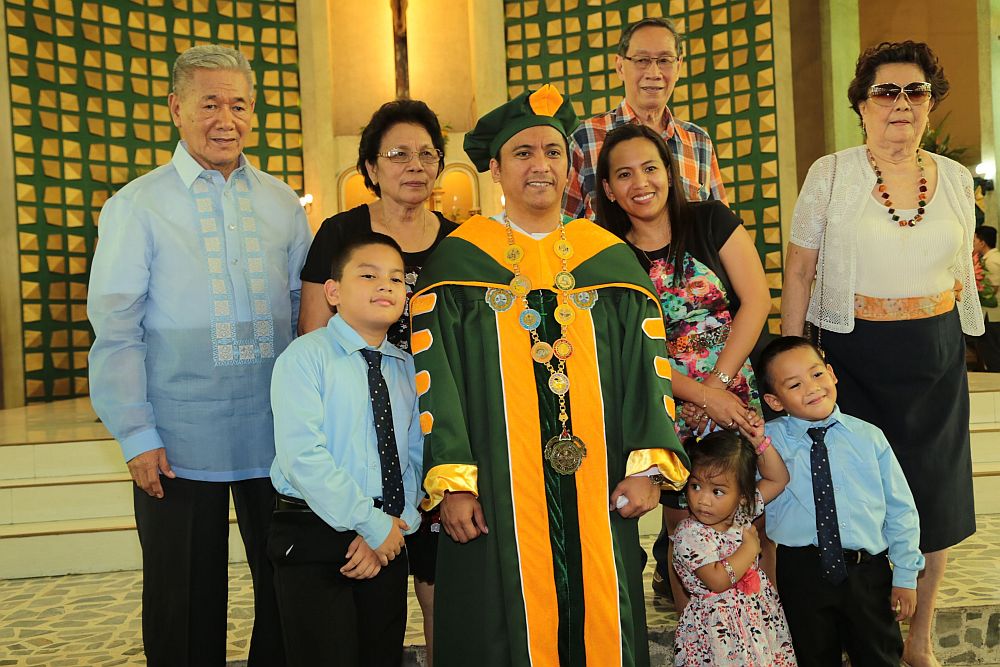 Fr. Maspara with his family during his installation as new president of USJ-R.  (CONTRIBUTED)