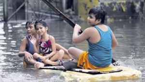 FLOOD PRINCESS A boy ferries children on a makeshift raft to their destination along a flooded portion of Road 10 in Tondo, Manila, after heavy rains brought by Tropical Storm “Egay.” (INQUIRER)