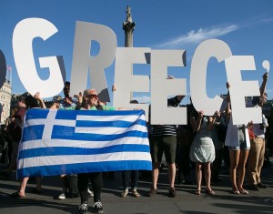 Demonstrators (left) holding letters to form a banner take part in a protest against the European Central Bank in Trafalgar Square, London, over Greece’s debt repayments. Above,  the Greek crisis has affected most the pensioners who didn’t receive their pensions after the banks declared bank holidays. (AP Photos)