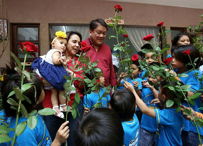 Children in the Parian Drop-in Center give red roses to birthday celebrant Cebu City Councilor Margot Osmeña, who has her  grandchild, Anita, in her arms. Margot turned 66 while husband Tomas turns  67 today. (CDN PHOTO/JUNJIE MENDOZA)
