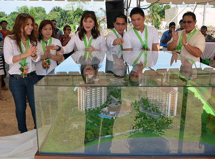 Shanna Louise Lopez, CEO of Nexus Real Estate Corp. (extreme left), and Rosita Te Lopez (3rd from left), the firm’s president, show Rep. Samsam Gullas and other guests a scale model of the condo complex they plan to build in Talisay City. (Right photo) Shanna Lopez pours cement on the time capsule during the groundbreaking ceremony. (CDN PHOTO/Christian Maningo)