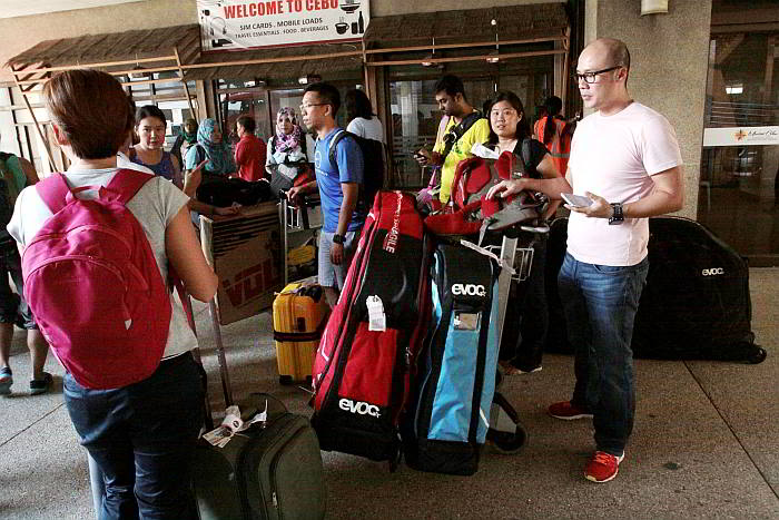 Athletes from Kuala Lumpur, Malaysia arrive with larger-than-usual bags of sports gear for the Ironman 70.3 on Sunday. (CDN PHOTO/ JUNJIE MENDOZA)