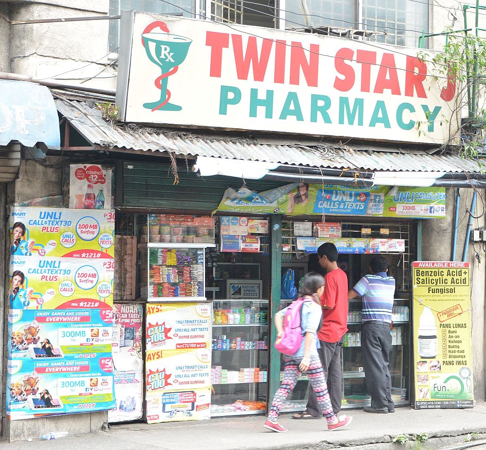 Augusto Isdiro, NBI 7 assistant regional director, points to boxes of confiscated medicine seized from  five small pharamcies like the Twin Star J Pharmacy (above)  along Sanciangko st., Cebu City.  CDN PHOTO/CHRISTIAN MANINGO and ADOR MAYOL