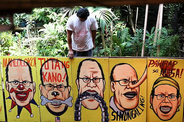 Placard-shields with different intepretations of Pres. Aquino being readied in KMU's head office in QC a day before his last SONA. (INQUIRER PHOTO/LYN RILLON)