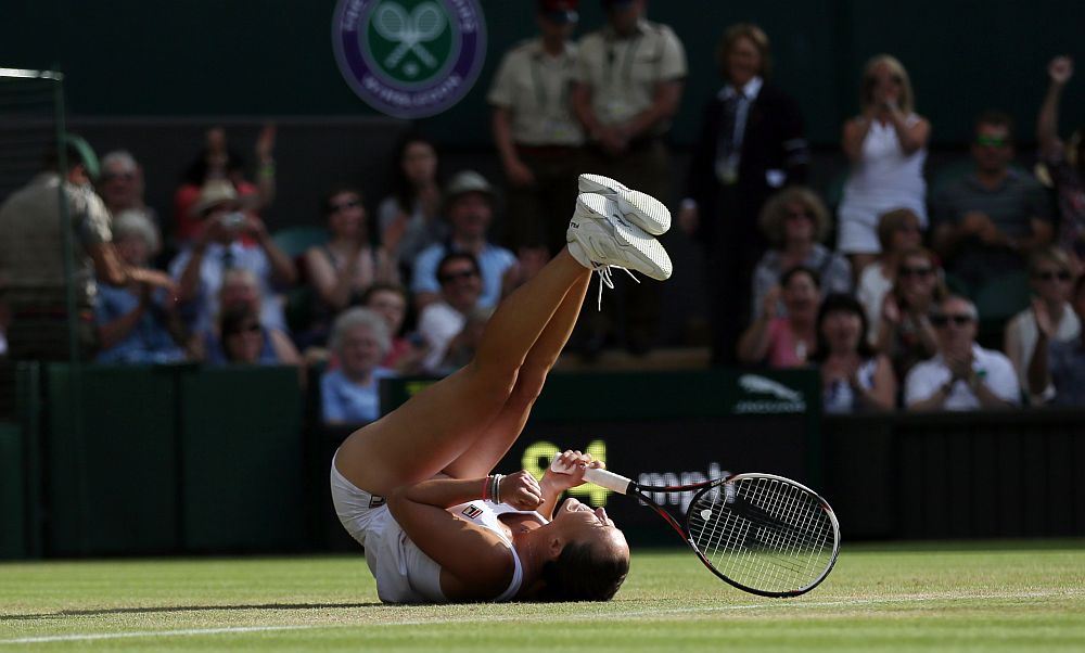 Jelena Jankovic of Serbia celebrates after defeating Petra Kvitova of the Czech Republic during their singles match at the All England Lawn Tennis Championships in Wimbledon, London.(AP)