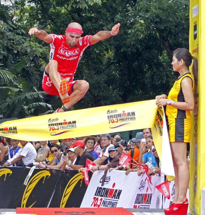 Mathieu O Halloran leaps as he reaches the finish line during the 2013 edition of the Cobra Ironman 70.3 Philippines. this year, participants can help a school in Talisay City if they go an extra mile after the finish line. (CDN FILE PHOTO)