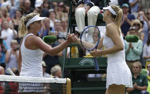 Maria Sharapova of Russia, right, shakes hands at the net Coco Vandeweghe of the United States, after winning their singles match, at the All England Lawn Tennis Championships in Wimbledon, London, Tuesday July 7, 2015. Sharapova won 6-3, 6-7, 6-2. (AP Photo/Pavel Golovkin)
