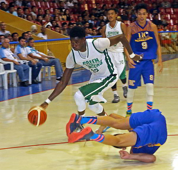 Steve Cedrick Akomo of the University of the Visayas sends his defender tumbling to the floor as he tries to drive into the lane in yesterday’s action of the Cesafi men’s basketball tournament at the Cebu Coliseum. (CDN PHOTO/LITO TECSON)