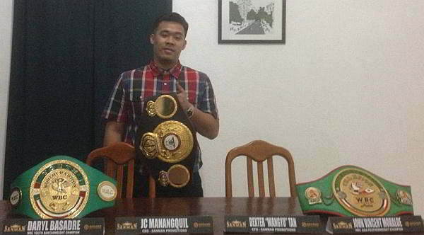 PRIZED WARE. JC Manangquil holds up a world title belt won by one of his wards at the Sanman Boxing Gym in General Santos City. (CONTRIBUTED PHOTO)