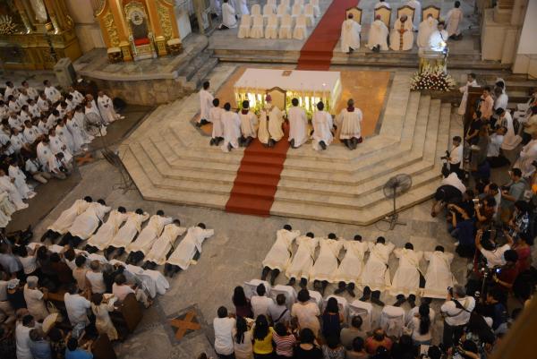 The 14 new priests lie flat on the floor, an act of total surrender to God, during their ordination at the Cebu Metropolitan Cathedral yesterday. (CDN PHOTO/ CHRISTIAN MANINGO)