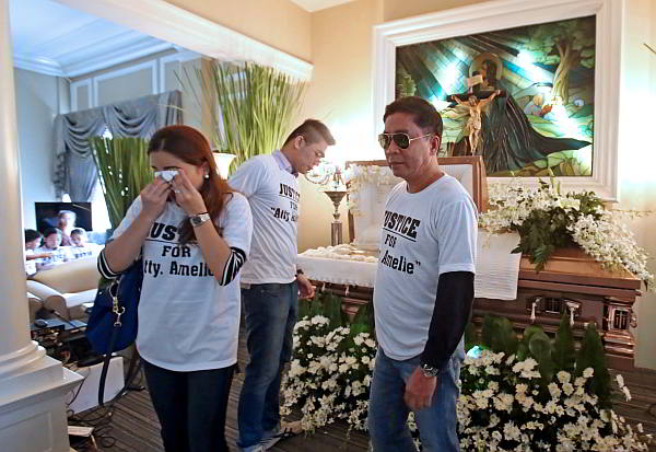 Lawyers Georgia Herrera-Klepp, Irish Dwight Remedio and Briccio Joseph Boholst  pay their last respects to their fallen law firm partner Amelie Ocañada-Alegre before her remains were cremated last Aug. 22. (CDN PHOTO/JUNJIE MENDOZA)