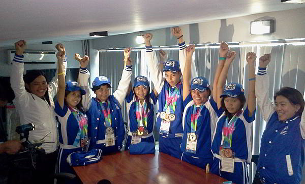 VICTORY POSE. With hands raised in triumph, Mandaue  athletes and their coach share their joy in the office of Mayor Jonas Cortes after competing in the Special Olympics World Summer Games. From left, coach  Carolina Ambray,  Jesabelle Cristy Mistula, Gia Gestopa, Mizzel Dawa, Filbert Canete, Catherine Alexandra Managay, Merasol Cutamora and  Maria Delia Minoza, coach and principal of Mandaue City Central SPED School. (CDN PHOTO/NORMAN MENDOZA)