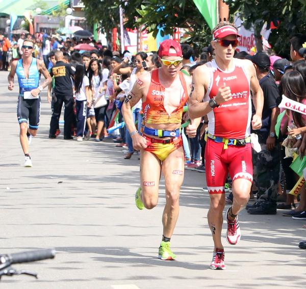 Triathlete run through a road lined with spectators in Lapu-Lapu City during last Sunday's Cobra Ironman 70.3 Philippine race. (CDN PHOTO/ LITO TECSON)