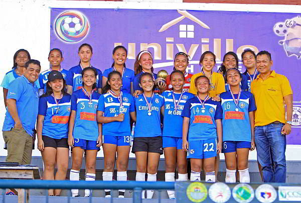 Players of the SHS-AdC under-18 girls team don their championship medals given out by Gerry Guardo (right), organizer of the 1st Univille 7-Aside Football Festival. (CDN PHOTO/LITO TECSON)
