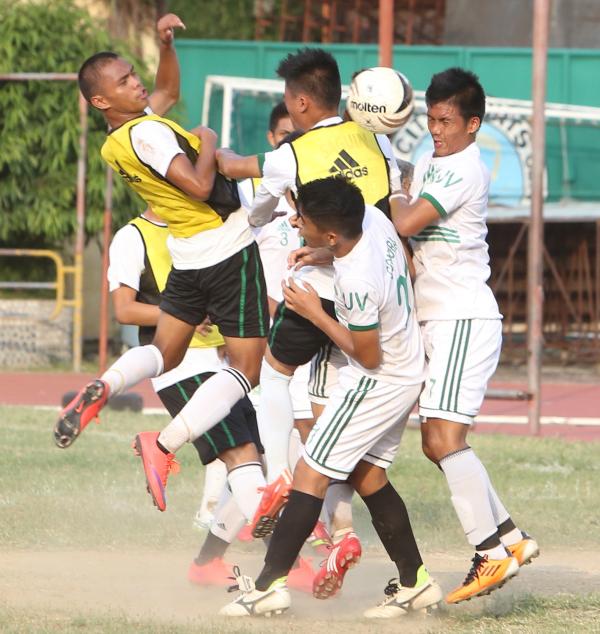 Booteres from USC and UV collide as they battle for ball possession in yesterday's Cesafi football game at the Cebu City Sports Center. (CDN PHOTO/ LITO TECSON)