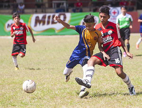 An Abellana National School booter (right) loses control of the ball against a Central Philippine University player during the Milo Little Olympics Regional Finals.  CPU won 1-0.