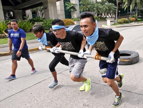 Aaargh, this is a maximum effort by CDN's Victor Anthony Silva, Calvin Cordova and Jose Santino S. Bunachita in the 'tire push and pull' exercise of the Metafit Boot Camp Challenge. (CDN PHOTO/ JUNJIE MENDOZA)