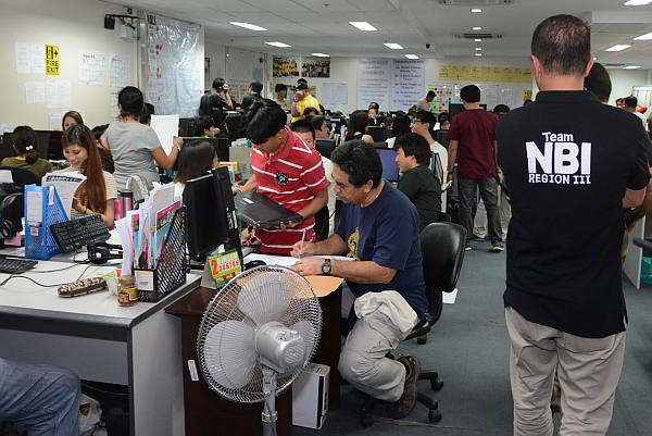 Arrested Japanese call center employees  are processed by agents of the National Bureau of Investigation  following their arrest on Friday. (CDN PHOTO/CHRISTIAN MANINGO)