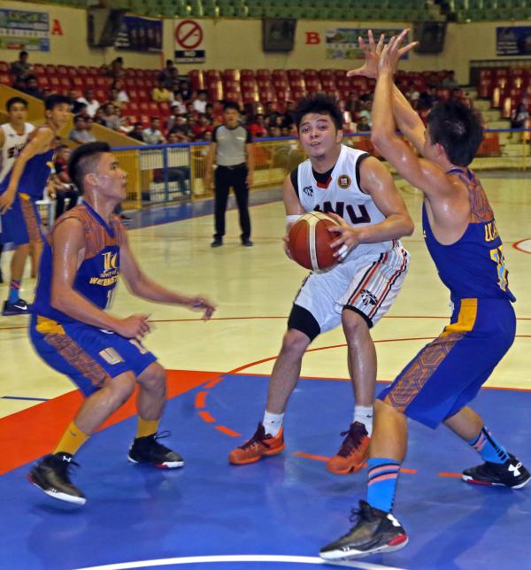 Jan Auditor of the SWU Cobras tries to shake off the defense of a former teamate at the University of Cebu during their Cesafi basketball game last night. (CDN PHOTO/ LITO TECSON)