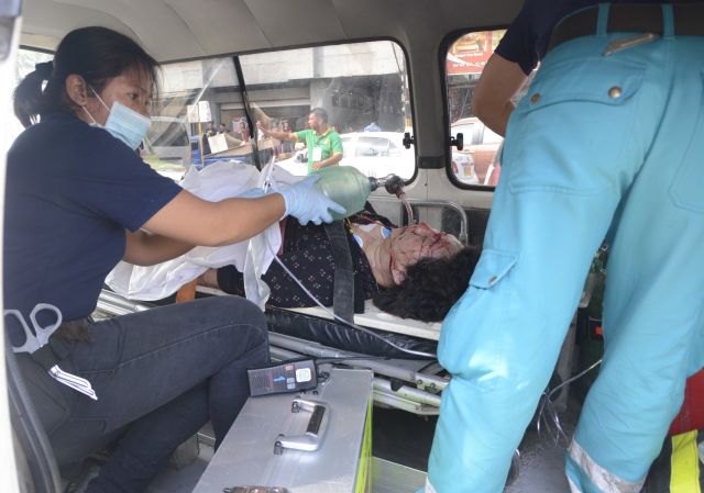 Consul Hui Li, who was shot in the chest, is attended to by paramedics in an ambulance after the Oct. 21 shooting. She didn't survive. (CDN PHOTO/CHRISTIAN MANINGO)
