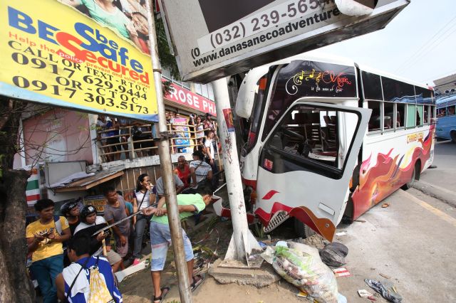 TWO DIED IN MINI BUS ACCIDENT/OCT. 24, 2015: The messege on the yellow billboard did not fit at the San Jose Mayan Mini bus which the front portion was totaly damage after it hits an electrict post at North Road National Highway corner Canduman street barangay Basak Mandaue City that injured about 19 passengers killed security guard Edwin Rago who is riding his bicycle and a pedestrian woman who were the first to his before the post.(CDN PHOTO/JUNJIE MENDOZA)