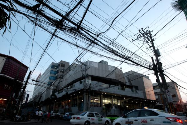 Utility firms claim that they have done improvements in areas where there are dangling and sagging wires but Councilor Nestor Archival Sr. who chairs the committee on utilities still has to see substantial improvement in most parts of the city. (CDN PHOTO/TONEE DESPOJO)