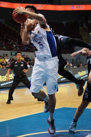 Former SWU Cobra Joseph Nalos, now playing for Adamson, hangs on to the neck of Ateneo’s Vince Tolentino in their game last Saturday. INQUIRER