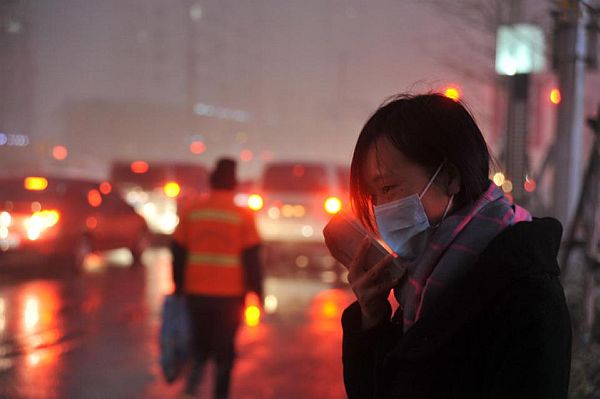 A woman wears a face mask amid a heavy haze in Shenyang in northeastern China's Liaoning province on Sunday. 