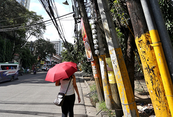 The scene of leaning utility posts holding up spaghetti wire was cited by Cebu City Mayor Michael Rama who saw the photo in Cebu Daily News front page on Tuesday. (CDN PHOTO/JUNJIE MENDOZA)