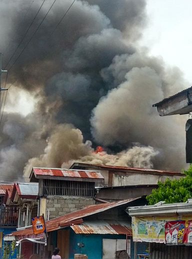 Photo of the fire that hit houses at Matumbo, Brgy. Pusok, Lapu-Lapu City early afternoon today. (CONTRIBUTED/ERIC AUSENTE)