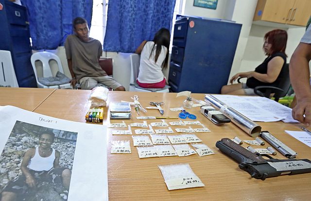 CATMON DRUGS/NOV. 7, 2015: Anthony Arizo Grape, Salome Chan and Ira Anthony Arizo Grape (L-R) were arrested by the elements of the Provincial Intelligents Bureau and the Catmon Police and confiscated almost a Million worth of illegal drugs Shabu,drug pharaphernalias .45 Cal.with live amunitions during a raid at Barangay Macaas, Catmon, Cebu that resulted to the killing of suspected drug pusher Zaldy Bravo (left picture) top ten personalities involved in illegal drugs of CPPO on PNP's Lambat-Sibat operation . Police also rescued two minors who were illegaly used as runners.(CDN PHOTO/JUNJIE MENDOZA)