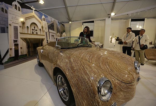 A car with a body made of coco flower stalks is displayed at the APEC expo.