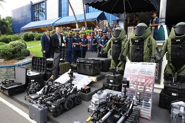 The anti-terrorism unit of the United States government donates 3 explosives ordinance disposal robots, 6 Ford Ranger pickup trucks and several bomb investigation materials and kits to bolster the police's security for the APEC Summit.