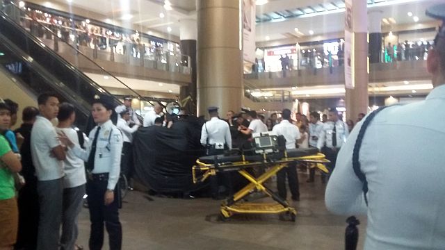 Black cloth panel blocks the view of the rescue operation of a boy who got his left foot snagged while descending on an escalator at the northwing of SM City Cebu.(CDN PHOTO APPLE MAE TA-AS)