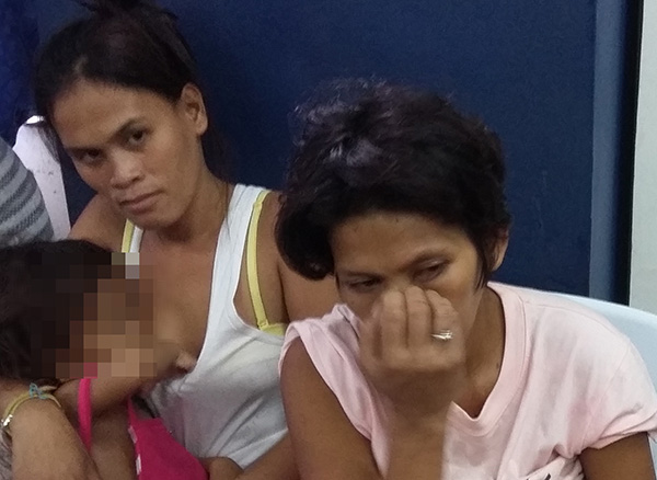 Two suspects in the drug raid are detained at the Provincial Intelligence Branch office. (CDN PHOTO APPLE MAE TA-AS)