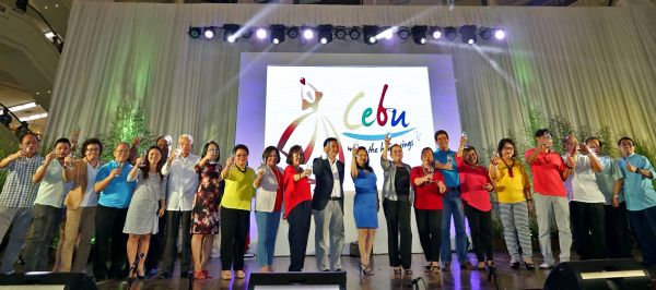 Tourism stakeholders in the Cebu Brand Team toast to the result of their collaboration during a grand unveiling at the Ayala Activity Center. The logo and tagline "Cebu, where the heart sings" is flashed on the screen after the program of songs and dances put together, like the brand, "for the love of Cebu." Cebu Chamber of Commerce and Industry president Tess Chan (center in blue) leads the salute. (CDN PHOTO/JUNJIE MENDOZA)