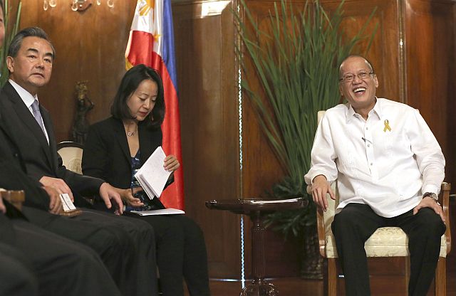 Philippine President Benigno Aquino III, right, smiles as he receives Chinese Foreign Minster Wang Yi, left, during a courtesy call at Malacanang Palace in Manila, Philippines Tuesday, Nov. 10, 2015. It was Wang's first visit to the country amid the two countries' row over the Spratly group of islands in the South China Sea. (AP Photo)