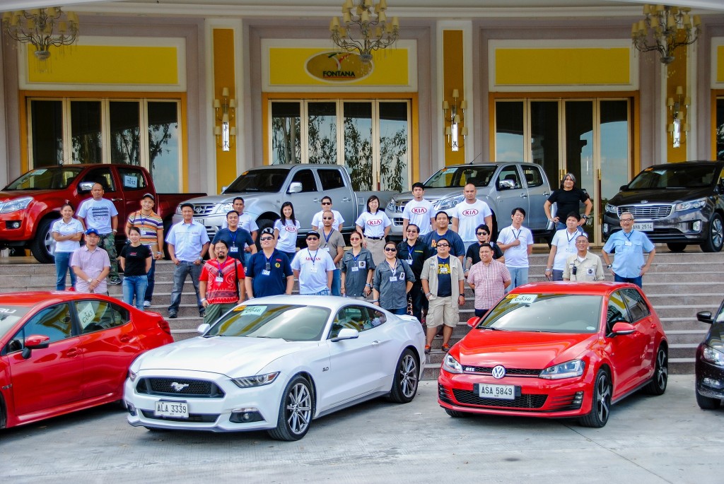 Members of CAGI pose with vehicles examined on the third testing day. contributed photo