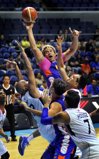 NLEX's 42-year-old center Asi Taulava goes up for a shot against Meralco's Kelly Nabong and Bryan Faundo. (INQUIRER PHOTO)