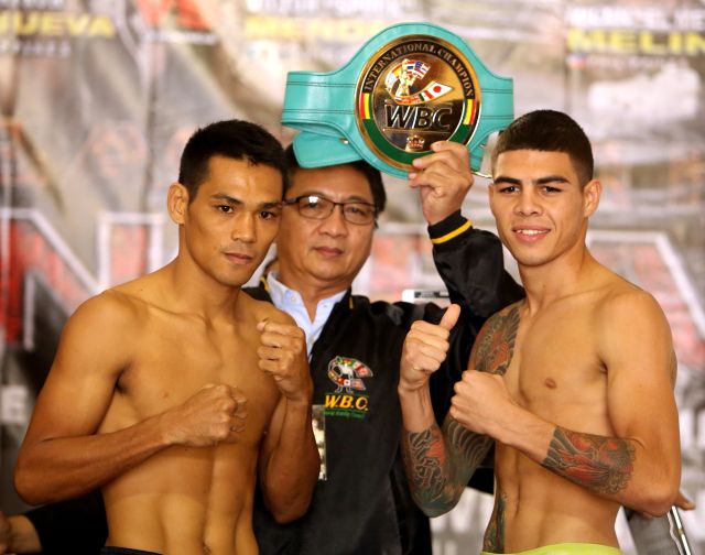 "King" Arthur Villanueva (left) and his Mexican opponent Victor " Spock" Mendez show their fighting form after their official weigh-in. Both will fight for the WBC International superflywight belt today in Lapu-Lapu City. (CDN PHOTO/LITO TECSON)