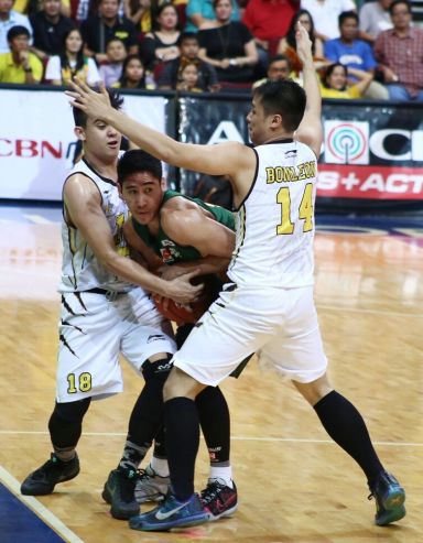 Mark Belo of FEU is double-teamed by UST's Louie Vigil and Mario Bonleon in Game 1 of the UAAP men's basketball finals last Wednesday. (INQUIRER PHOTO)