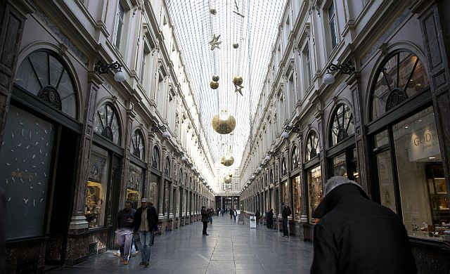 People shop in a nearly empty arcade in the center of Brussels on Monday. (AP)