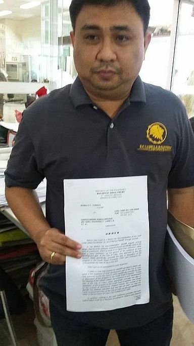 City Legal Officer Jerone Castillo shows a copy of the order from the Regional Trial Court denying the motion for reconsideration filed by Lawyer  