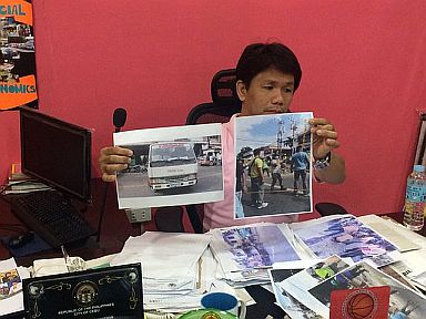 Labangon barangay captain Victor Buendia, who filed the case, said he hasn't received a copy of the order. Here he showed photos of City Hall team demolishing center island and street lighting project  in Labangon last year.