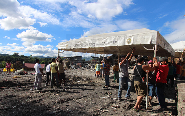 The Cebu City government sets up tents at the fire site in Lahug after bulldozing and clearing out debris for plans to re-block the area for residents. (CDN PHOTO/TONEE DESPOJO)