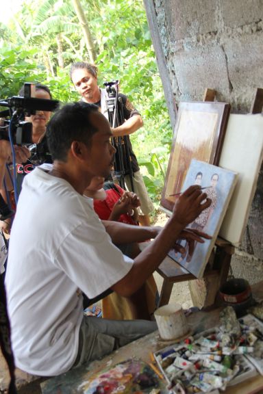 Arnel Salvacion demonstrates his painting talent during a media tour and learning visit in Tuburan town, northwest Cebu.