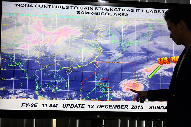 A Pagasa forecaster shows the path of typhoon Nona as it picks up strength and heads toward the Samar-Bicol area. (INQUIRER PHOTO)
