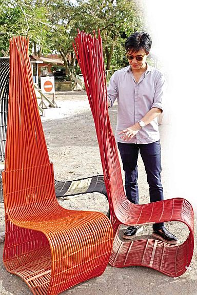 Kenneth Cobonpue checks out  illegal reproductions of his design of the Yoda chair before the fake pieces are destroyed. (INQUIRER PHOTO)