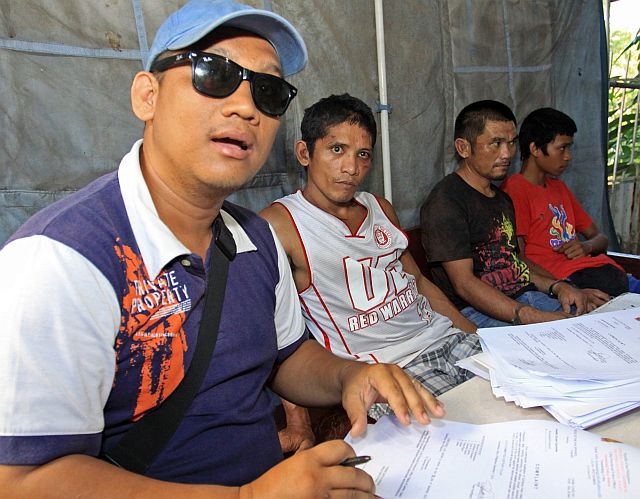 DUMANJUG AMBUSH SUSPECT FILE CASE/DEC.07,2015:Dumanjug Police Station Chief Snr. Insp. Arvi Arbuis answer question from the media regarding the Dumanjug ambush with him are the suspect (left to right) Samuel Villagonzalo,Joselito Quirante and Dexter James Aniñon during their filing of the case at the prosecutors office.(CDN PHOTO/LITO TECSON)