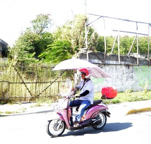 SILOY IS WATCHING/DEC. 20, 2015 Due to scorching heat, a man attached an umbrella on his motorcycle. Is this legal now in the Philippines? (CDN PHOTO/CHRISTIAN MANINGO)